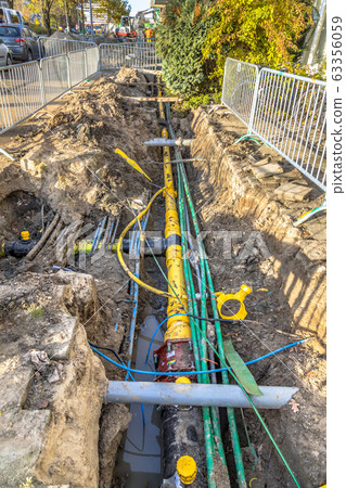 cables, pipes and sewage under pedestrian walkway 63356059