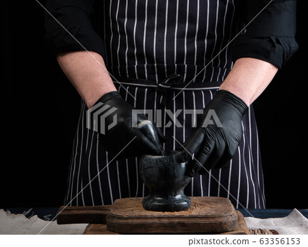 chef man holding a stone mortar and pestle for chef man holding a stone mortar and pestle for 63356153