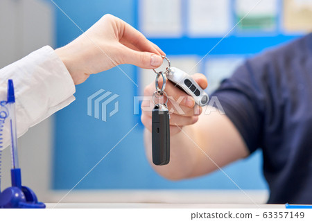 Rusty drum brakes, rear on red car. Change the old to new brake disc on car in a garage. Auto mechanic repairing 63357149