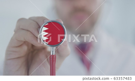 Doctor uses stethoscope with the Bahraini flag. Healthcare in Bahrain 63357483