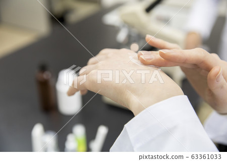 Image of cosmetics development Hands of a female researcher developing a hand cream Image of cosmetics development Hands of a female researcher developing a hand cream 63361033