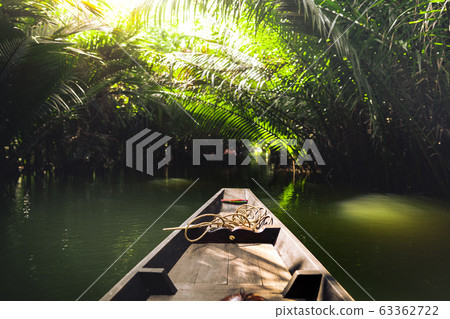 Travel on a wooden boat in the floating market. 63362722