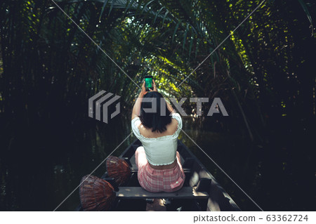 Travel on a wooden boat in the floating market. Travel on a wooden boat in the floating market. 63362724