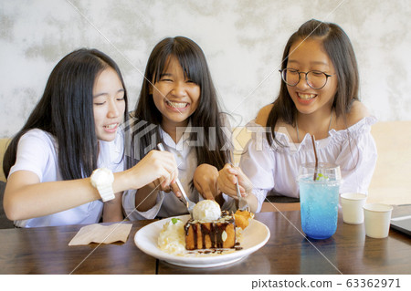 group of asian teenager eating icecram toast in group of asian teenager eating icecram toast in 63362971