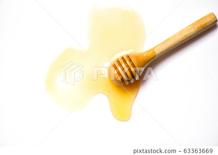 Wooden dipper honey yellow sweet on white 63363669