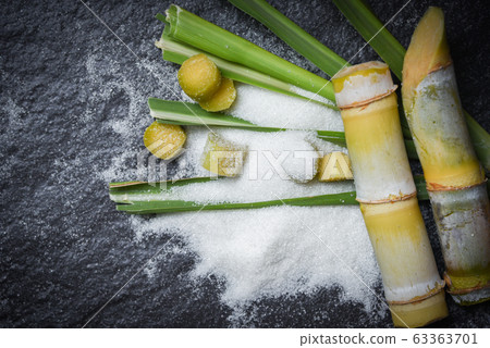 White sugar and and green of leaf cut sugar cane White sugar and and green of leaf cut sugar cane 63363701