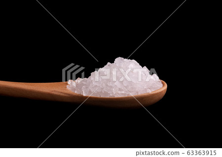 Large crystals of salt in a spoon close-up. Large crystals of salt in a spoon close-up. 63363915