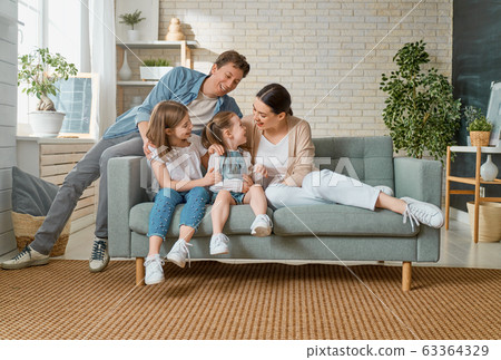 Two children with mother and father. Two children with mother and father. 63364329