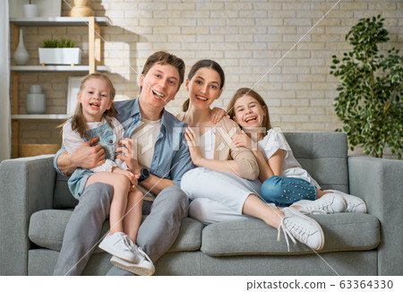 Two children with mother and father. Two children with mother and father. 63364330