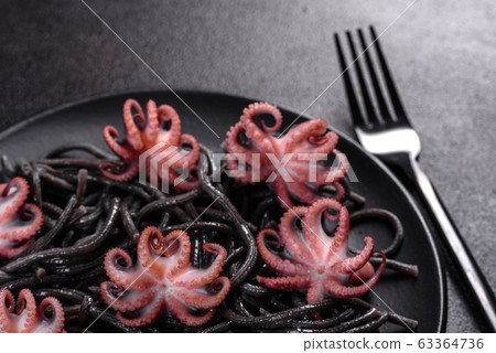 Black seafood pasta with shrimp and octopus 63364736