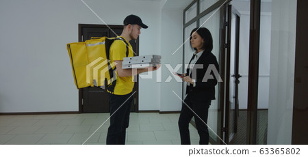 Businesswoman paying for food delivery Businesswoman paying for food delivery 63365802