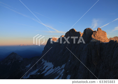 Glacier with rocks in Austria with snow during sunrise Glacier with rocks in Austria with snow during sunrise 63365883
