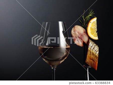 Glass of white wine and smoked mackerel with lemon Glass of white wine and smoked mackerel with lemon 63366634