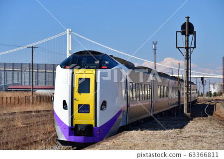 Take a picture of the scenery of the limited express Hokuto passing through JR Motowa Nishi Station in Muroran City, Hokkaido in early spring 63366811
