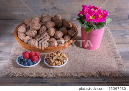 walnuts with berries and flowers 63367980