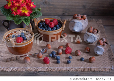hazelnuts on a table with sprinkled berries and 63367983