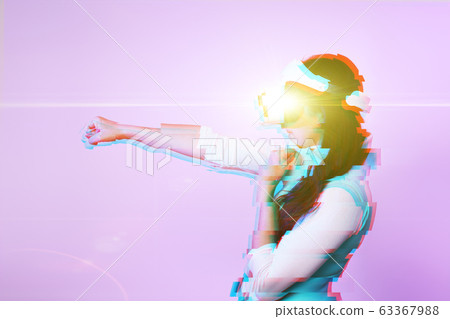 Woman is using virtual reality headset. Image with glitch effect. Woman is using virtual reality headset. Image with glitch effect. 63367988