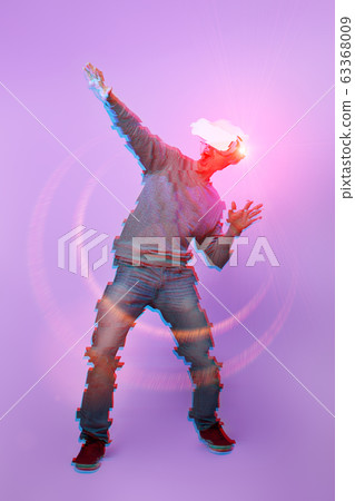 Man is using virtual reality headset. Image with glitch effect. 63368009