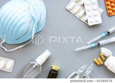Blue medical mask and medicine pills Blue medical mask and medicine pills 63369576