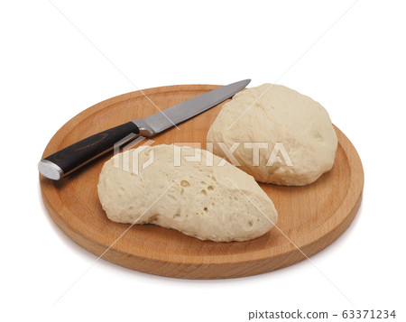 fresh raw sliced dough on wooden board isolated on white background 63371234