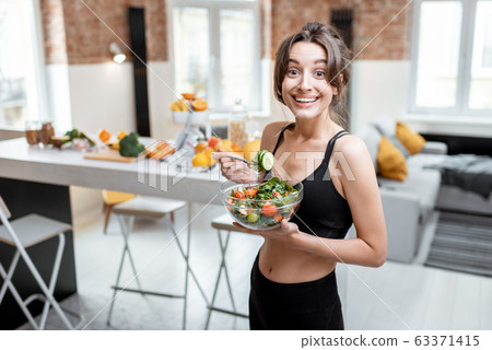 Sports woman with healthy food at home Sports woman with healthy food at home 63371415