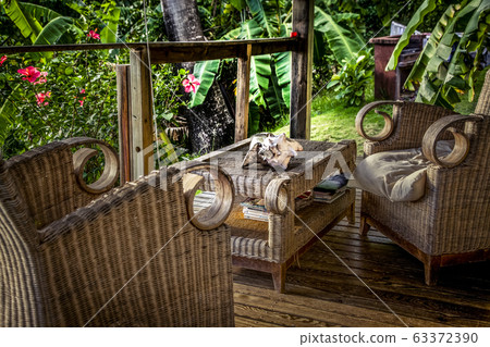 wooden terrace with chairs in a tropical garden wooden terrace with chairs in a tropical garden 63372390