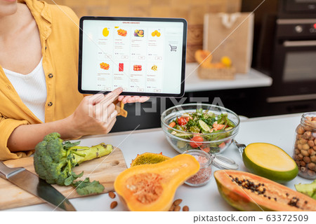 Woman shopping online using digital tablet Woman shopping online using digital tablet 63372509