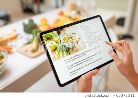 Cooking food using recipe on a digital tablet 63372511