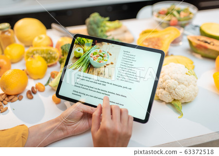 Cooking food using recipe on a digital tablet Cooking food using recipe on a digital tablet 63372518