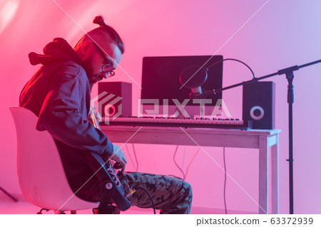 Musician and making music concept - Male sound producer working in recording studio. 63372939