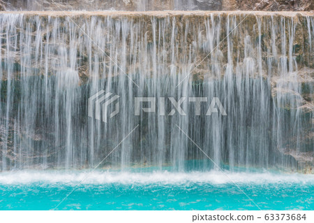 landscape of beautiful Artificial waterfall in garden at the public park. 63373684