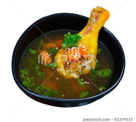 Delicious soup with chicken, bacon, leek and vegetables served in bowl 63374533