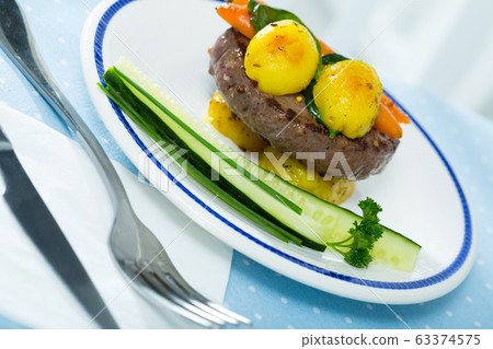 Beef rissole baked with potato Beef rissole baked with potato 63374575