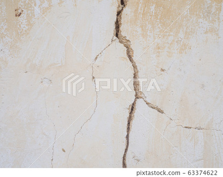 Cement concrete wall was cracked, beige color paint peel.  63374622