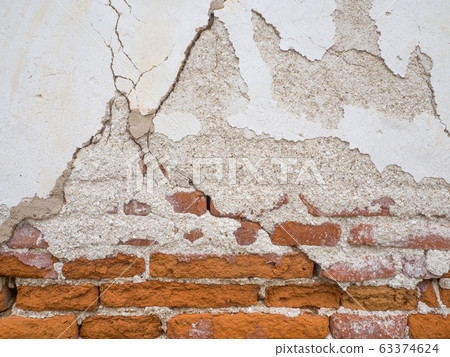 Cement concrete wall was cracked, beige color paint peel.  63374624