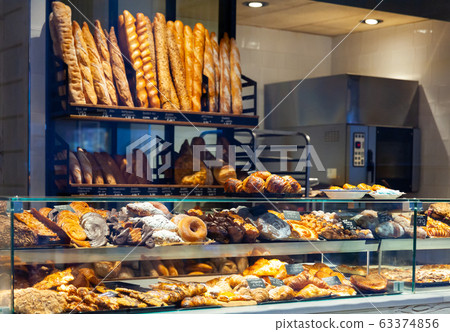 Bakery shop with assortment of bread on shelves Bakery shop with assortment of bread on shelves 63374856