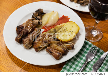 Tasty veal kebab and baked potatoes served at plate Tasty veal kebab and baked potatoes served at plate 63375071