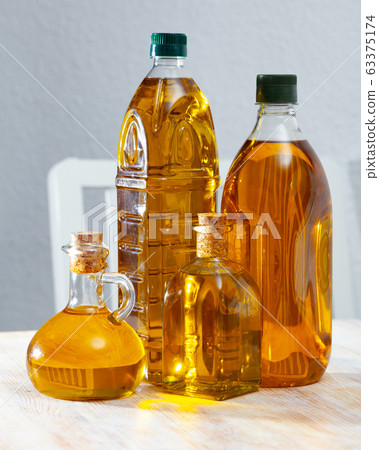Vegetable oil on wooden table Vegetable oil on wooden table 63375174