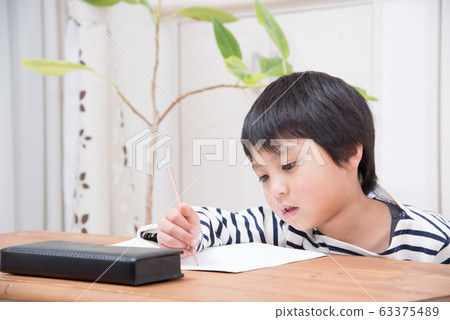 Elementary school boy studying Elementary school boy studying 63375489