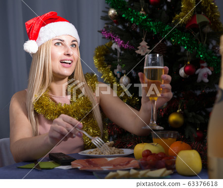 Girl is celebrating New Year with champagne Girl is celebrating New Year with champagne 63376618