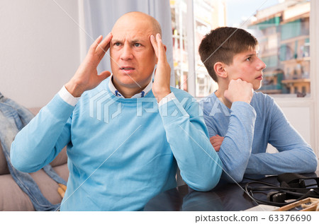 Father and teenage son after quarrel Father and teenage son after quarrel 63376690