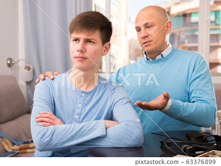 Father calming upset teenage son Father calming upset teenage son 63376899