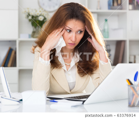 Adult woman is crying because of problems with documents 63376914