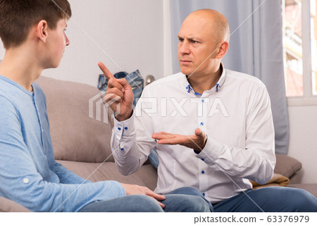 Father lecturing his teenage son Father lecturing his teenage son 63376979