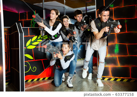 Group glad people playing laser tag game 63377158