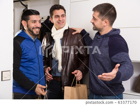 Man meeting male friends at home Man meeting male friends at home 63377170