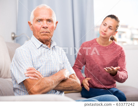 Portrait of upset senior man and daughter quarrelling at home Portrait of upset senior man and daughter quarrelling at home 63377242