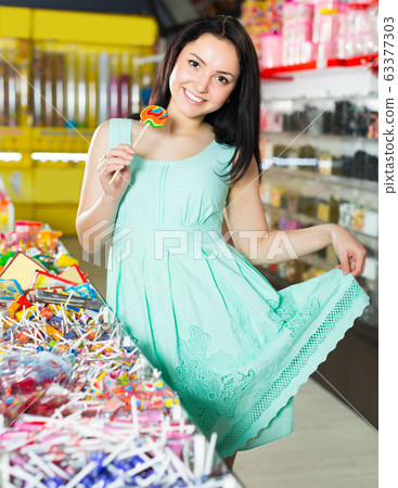 sexy smiling female posing in the store with lolly sexy smiling female posing in the store with lolly 63377303