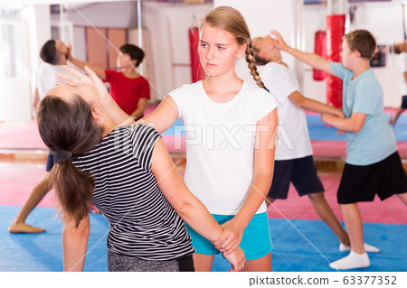 Kids exercising self-defense movements Kids exercising self-defense movements 63377352