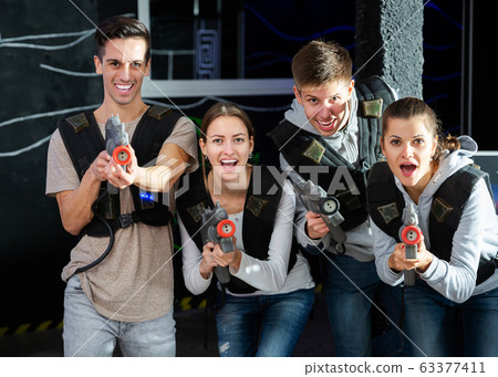 Friends playing lasertag game 63377411